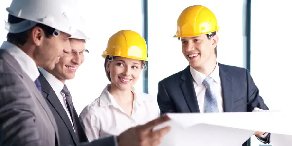 Business People With Hardhats Having A Meeting