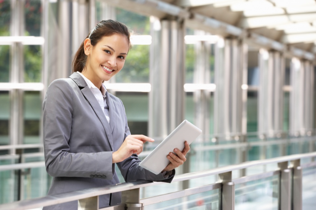 A Smiling Woman With A Tablet